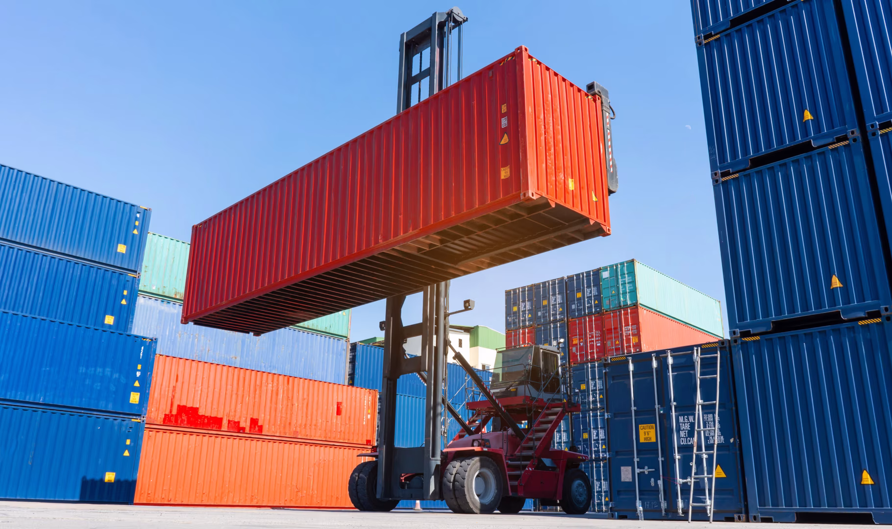 forklift working in the container cargo yard port loading cargo tank  logistic service and transportation concept.